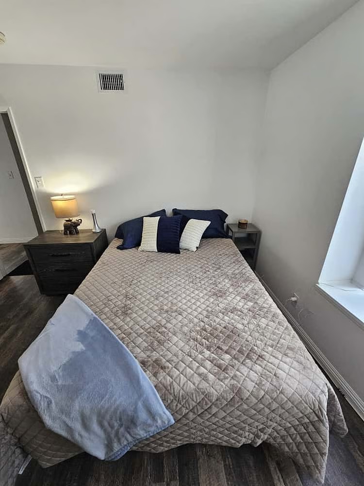 Furnished private bedroom with queen bed